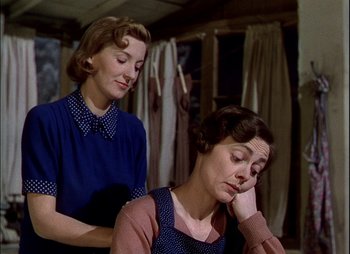Movie still from “This Happy Breed” (1944), directed by David Lean – Two women in blue shirts and a brown shirt; Medium shot, Low angle