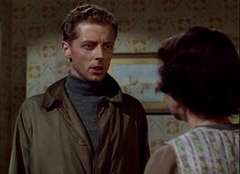 Movie still from “This Happy Breed” (1944), directed by David Lean – A man and a woman are standing in front of a painting; Close Up shot, Over the shoulder angle