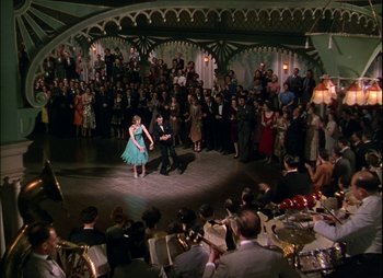 Movie still from “This Happy Breed” (1944), directed by David Lean – A couple of people that are dancing in a room; Extreme Wide shot, High angle