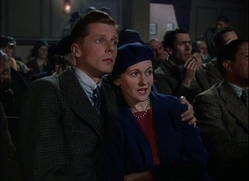 Movie still from “This Happy Breed” (1944), directed by David Lean – A man and a woman sitting next to each other; Medium shot, Low angle