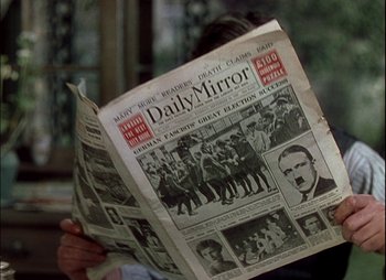 Movie still from “This Happy Breed” (1944), directed by David Lean – A person reading a newspaper in front of a window; Close Up shot, Over the shoulder angle