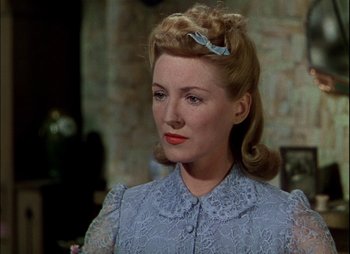 Movie still from “This Happy Breed” (1944), directed by David Lean – A person wearing a dress; Close Up shot, Over the shoulder angle