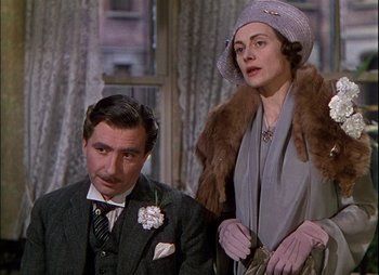 Movie still from “This Happy Breed” (1944), directed by David Lean – An older man sitting next to an older woman; Medium shot, Low angle