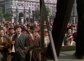 Movie still from “This Happy Breed” (1944), directed by David Lean – A group of people standing in front of a building; Wide shot, Low angle