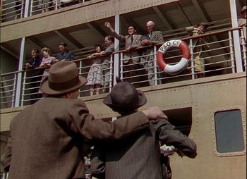 Movie still from “This Happy Breed” (1944), directed by David Lean – A group of people standing on a deck of a ship; Wide shot, High angle
