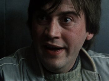 Movie still from “Threads” (1984), directed by Mick Jackson – A person with a sweater on; Close Up shot, High angle