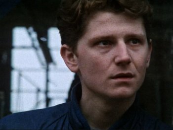 Movie still from “Threads” (1984), directed by Mick Jackson – A person wearing a jacket; Close Up shot, Low angle