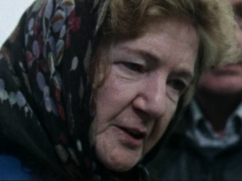 Movie still from “Threads” (1984), directed by Mick Jackson – An older woman wearing a black and white scarf; Close Up shot, Over the shoulder angle