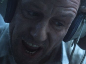 Movie still from “Threads” (1984), directed by Mick Jackson – A person wearing headphones; Extreme Close Up shot, Overhead angle