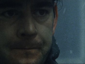 Movie still from “Threads” (1984), directed by Mick Jackson – A man's face in the snow; Extreme Close Up shot, Low angle