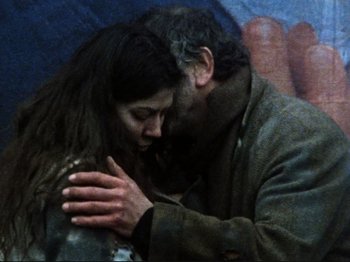 Movie still from “Threads” (1984), directed by Mick Jackson – A man and a woman kissing in front of a painting; Close Up shot, Low angle