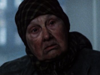 Movie still from “Threads” (1984), directed by Mick Jackson – An old woman wearing a hat and a scarf; Close Up shot, Low angle