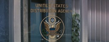 Movie still from “Three Coins in the Fountain” (1954), directed by Jean Negulesco – The united states department of the treasury has a sign on the door of the building; Medium shot, Low angle