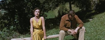 Movie still from “Three Coins in the Fountain” (1954), directed by Jean Negulesco – A man and a woman sitting on a wooden bench; Medium shot, High angle