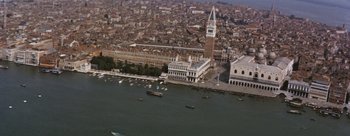 Movie still from “Three Coins in the Fountain” (1954), directed by Jean Negulesco – An aerial view of a large city with boats in the water; Extreme Wide shot, High angle