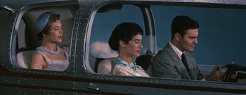 Movie still from “Three Coins in the Fountain” (1954), directed by Jean Negulesco – A woman sitting in the passenger seat of an airplane; Medium shot, Low angle