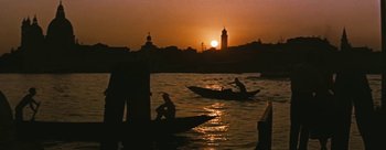 Movie still from “Three Coins in the Fountain” (1954), directed by Jean Negulesco – A couple of people on small boats in a body of water at sunset; Extreme Wide shot, Low angle