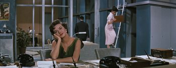 Movie still from “Three Coins in the Fountain” (1954), directed by Jean Negulesco – A woman sitting at a table in front of a man; Medium shot, High angle