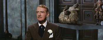 Movie still from “Three Coins in the Fountain” (1954), directed by Jean Negulesco – An older man wearing a suit and tie; Close Up shot, Over the shoulder angle