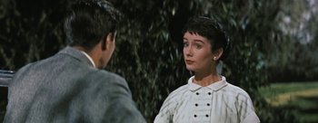Movie still from “Three Coins in the Fountain” (1954), directed by Jean Negulesco – A woman in a white shirt and a man in a black shirt; Close Up shot, Over the shoulder angle