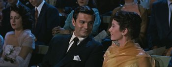 Movie still from “Three Coins in the Fountain” (1954), directed by Jean Negulesco – A man and a woman sitting next to each other; Close Up shot, Over the shoulder angle