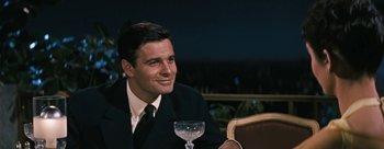 Movie still from “Three Coins in the Fountain” (1954), directed by Jean Negulesco – A man sitting at a table with a glass of wine; Close Up shot, Over the shoulder angle