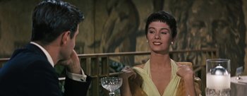 Movie still from “Three Coins in the Fountain” (1954), directed by Jean Negulesco – A man and a woman sitting in front of a wine glass; Close Up shot, Over the shoulder angle