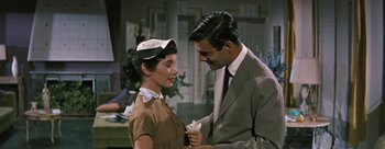 Movie still from “Three Coins in the Fountain” (1954), directed by Jean Negulesco – A man and a woman standing next to each other; Medium shot, High angle