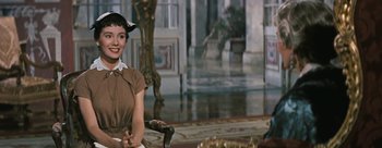 Movie still from “Three Coins in the Fountain” (1954), directed by Jean Negulesco – A woman sitting in front of a mirror in a room; Medium shot, Over the shoulder angle