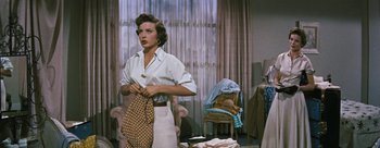 Movie still from “Three Coins in the Fountain” (1954), directed by Jean Negulesco – A woman holding a pair of polka dot gloves; Medium shot, Low angle