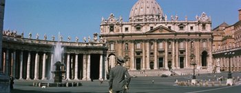 Movie still from “Three Coins in the Fountain” (1954), directed by Jean Negulesco – A man standing in front of an old building; Extreme Wide shot, Low angle