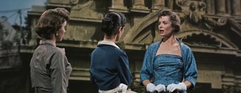 Movie still from “Three Coins in the Fountain” (1954), directed by Jean Negulesco – Two women talking to each other in front of a building; Medium shot, Over the shoulder angle