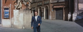 Movie still from “Three Coins in the Fountain” (1954), directed by Jean Negulesco – A man in a blue suit and a white tie; Wide shot, Low angle