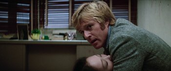 Movie still from “Three Days of the Condor” (1975), directed by Sydney Pollack – A man and a woman in a room with a sink; Close Up shot, Low angle