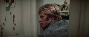 Movie still from “Three Days of the Condor” (1975), directed by Sydney Pollack – A person with long blonde hair; Close Up shot, Low angle