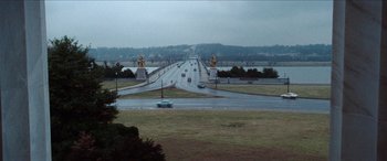 Movie still from “Three Days of the Condor” (1975), directed by Sydney Pollack – Cars driving down a road near a body of water; Extreme Wide shot, High angle