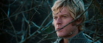 Movie still from “Three Days of the Condor” (1975), directed by Sydney Pollack – A man's face through a tree branch; Close Up shot, Low angle