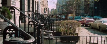 Movie still from “Three Days of the Condor” (1975), directed by Sydney Pollack – A city street with a lot of trees and buildings; Wide shot, High angle