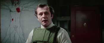 Movie still from “Three Days of the Condor” (1975), directed by Sydney Pollack – A person wearing a vest; Close Up shot, Over the shoulder angle