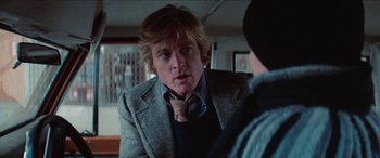 Movie still from “Three Days of the Condor” (1975), directed by Sydney Pollack – A person talking to another person; Close Up shot, Over the shoulder angle