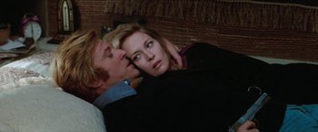 Movie still from “Three Days of the Condor” (1975), directed by Sydney Pollack – A man and a woman laying on a bed; Close Up shot, Over the shoulder angle