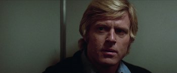 Movie still from “Three Days of the Condor” (1975), directed by Sydney Pollack – A person with long blonde hair; Close Up shot, Low angle