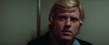 Movie still from “Three Days of the Condor” (1975), directed by Sydney Pollack – A person with long blonde hair; Close Up shot, Low angle