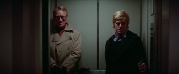 Movie still from “Three Days of the Condor” (1975), directed by Sydney Pollack – A man and a woman standing next to each other; Medium shot, Low angle