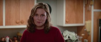 Movie still from “Three Days of the Condor” (1975), directed by Sydney Pollack – A person wearing a red shirt in a room; Close Up shot, Over the shoulder angle