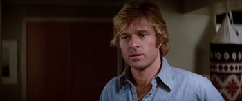 Movie still from “Three Days of the Condor” (1975), directed by Sydney Pollack – A person with long hair; Close Up shot, Over the shoulder angle