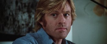 Movie still from “Three Days of the Condor” (1975), directed by Sydney Pollack – A person with long blonde hair; Close Up shot, Low angle