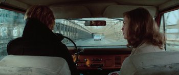 Movie still from “Three Days of the Condor” (1975), directed by Sydney Pollack – Two people in a car looking out of the window; Wide shot, Over the shoulder angle