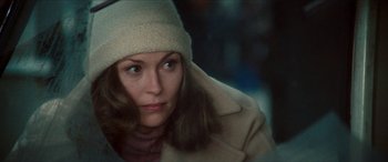 Movie still from “Three Days of the Condor” (1975), directed by Sydney Pollack – A person wearing a coat and a hat; Close Up shot, Over the shoulder angle