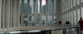 Movie still from “Three Days of the Condor” (1975), directed by Sydney Pollack – A group of people walking in front of a large building; Extreme Wide shot, High angle
